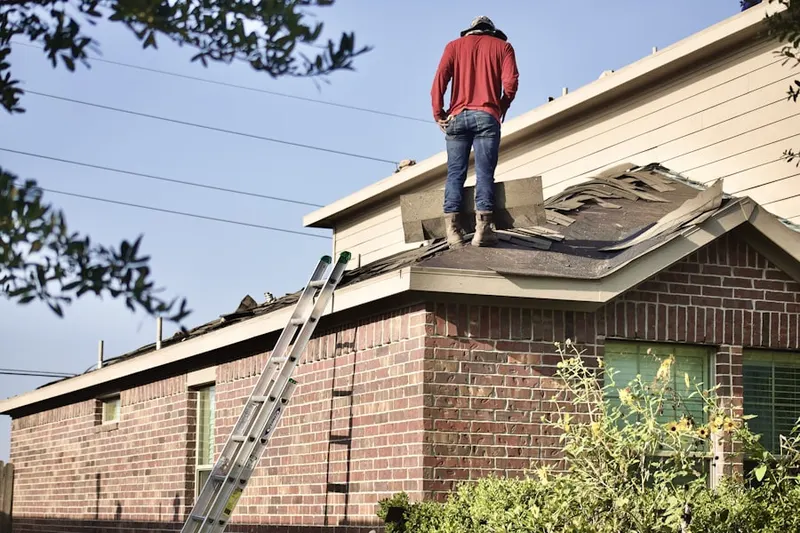 Professional roofer working on a residential roof in Plum Grove Village